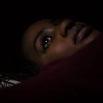 Personne allongee dans une chambre sombre la nuit