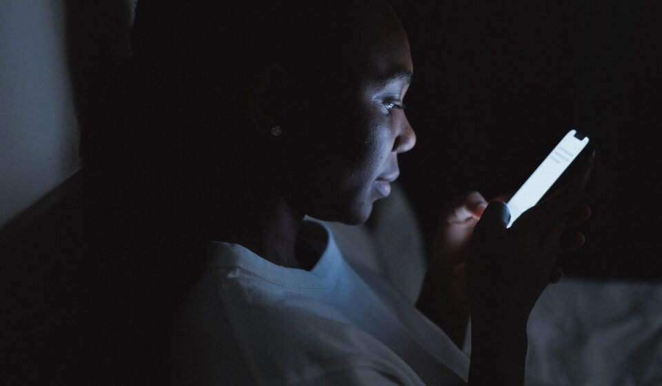 Personne consultant son smartphone la nuit, inquiete